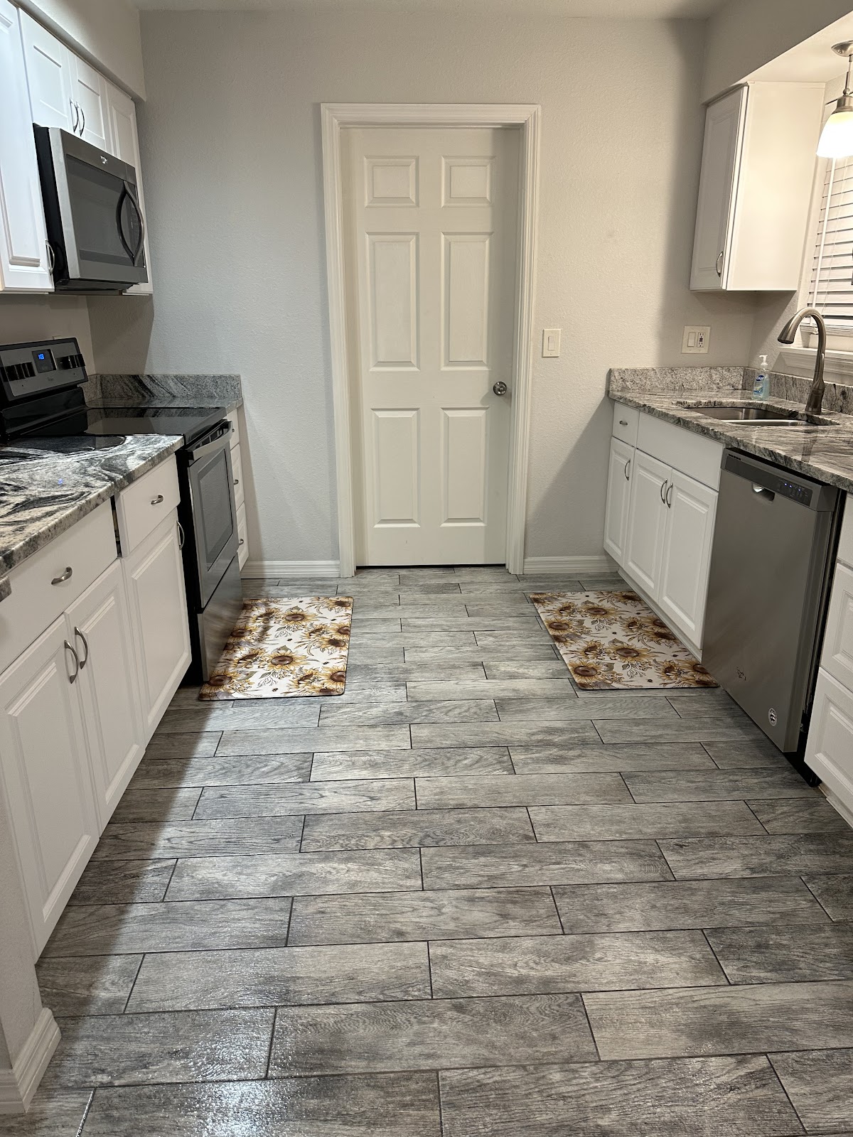 White kitchen cabinets and tile flooring
