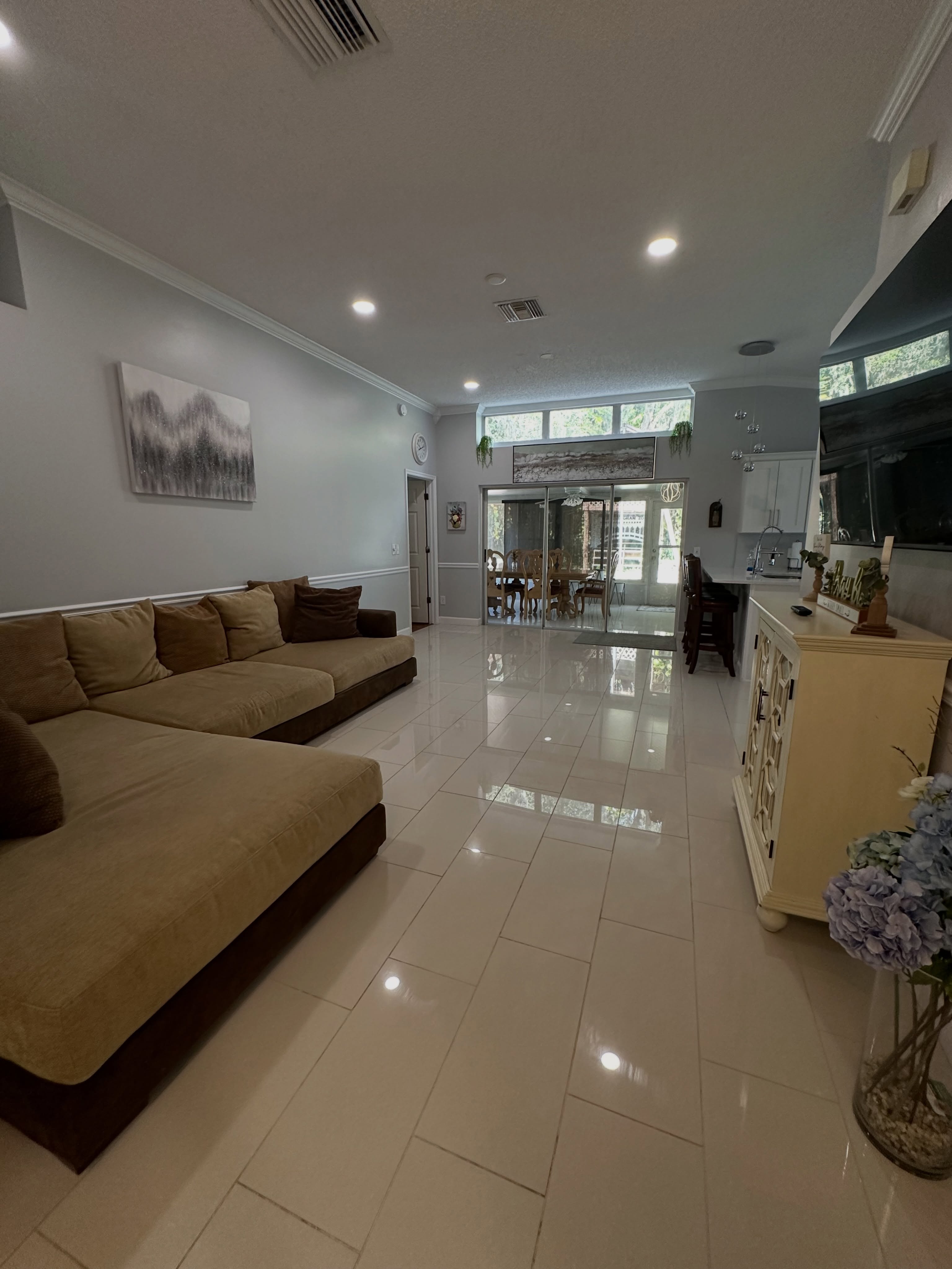 Living room with sofa and polished tile floors